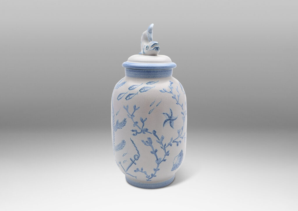 Gallery BAC tall ovoid form with fish form finial, glazed in a craquel white, surrounded with charming hand-painted pictures of marine flora and fauna in blue