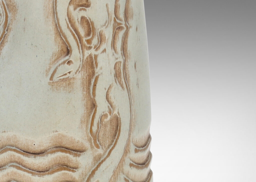 Gallery BAC upward tapering bottle-like form with dragon reliefs and carved wave design, glazed in a pale greenish gray with brown accents