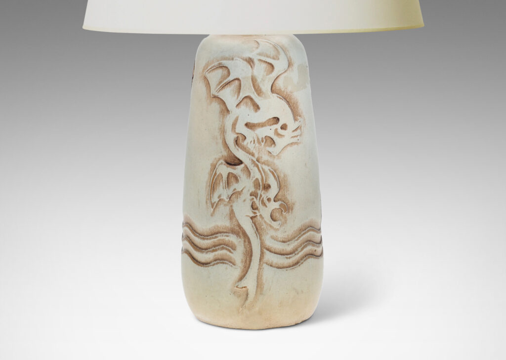 Gallery BAC upward tapering bottle-like form with dragon reliefs and carved wave design, glazed in a pale greenish gray with brown accents