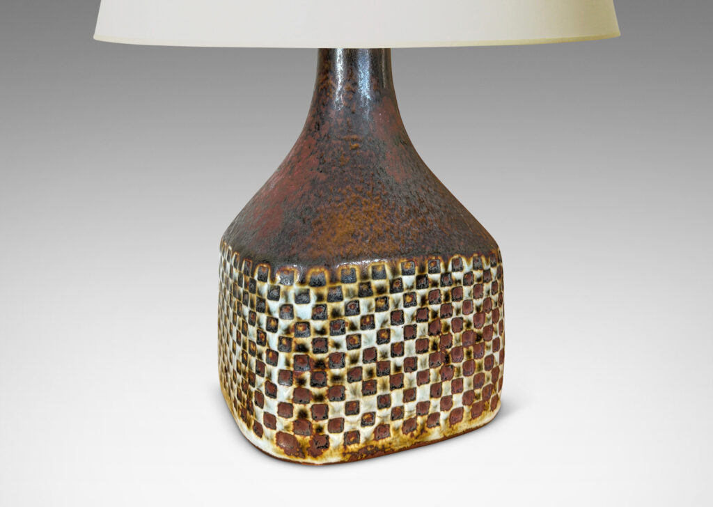 Gallery BAC square bottle-like form with checker relifs and sprouting neck, glazed in pale gray and oxblood-black