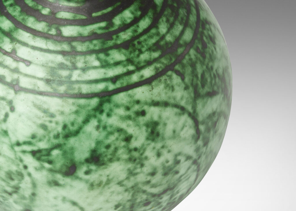 Gallery BAC globe form with carved pinstripe band details, glazed in a malachite-evoking rag rolled green glaze