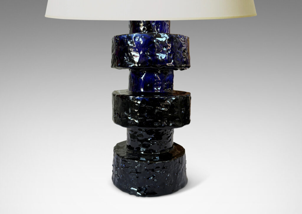 Gallery BAC coined stack of cylindrical forms in textured grog, with a deep flowing gloss blue glaze