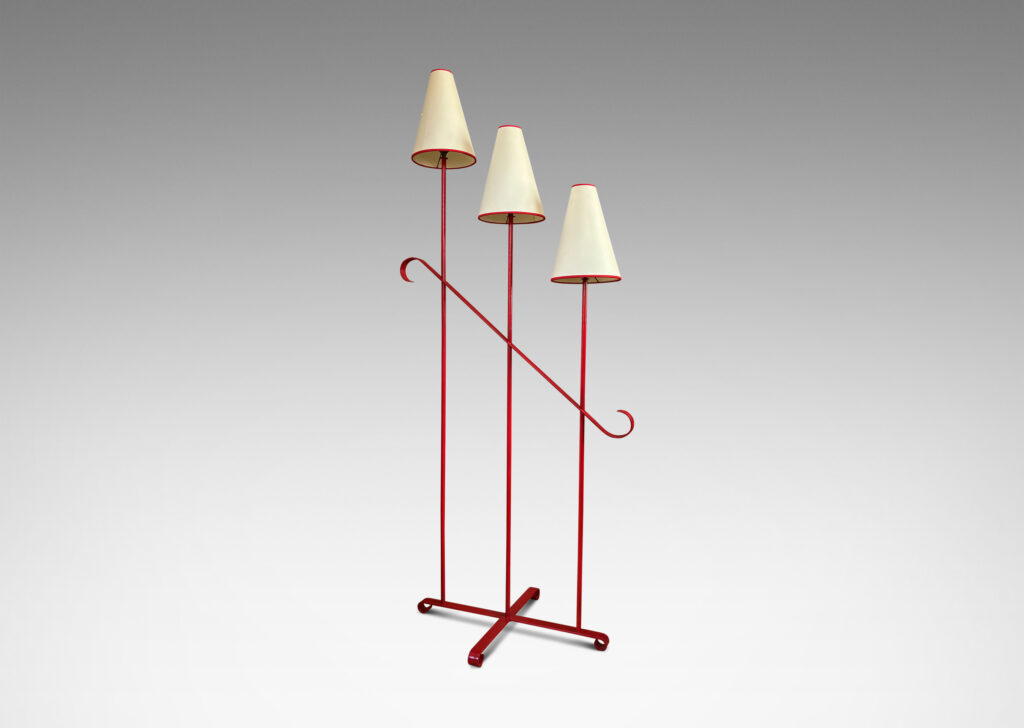 Gallery BAC three tiered stands topped with lights, joined by a scrolled brace and mounted on a cross form base with scroll feet, painted red