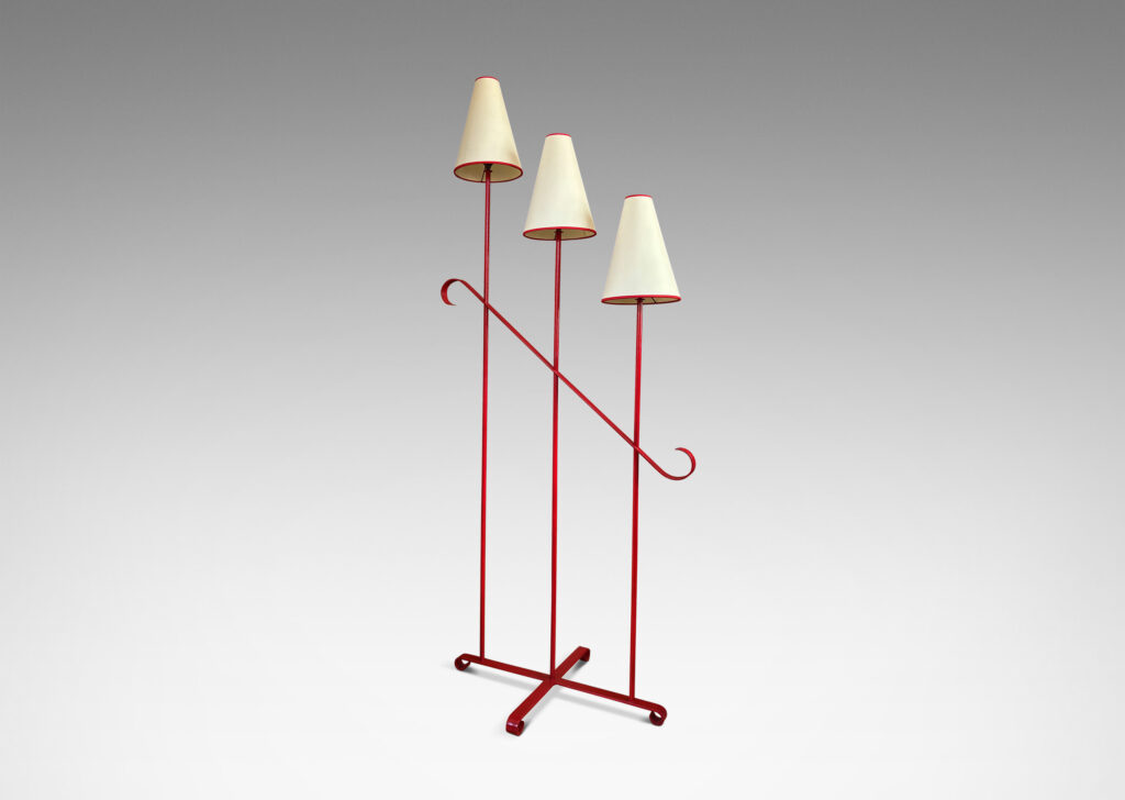 Gallery BAC three tiered stands topped with lights, joined by a scrolled brace and mounted on a cross form base with scroll feet, painted red