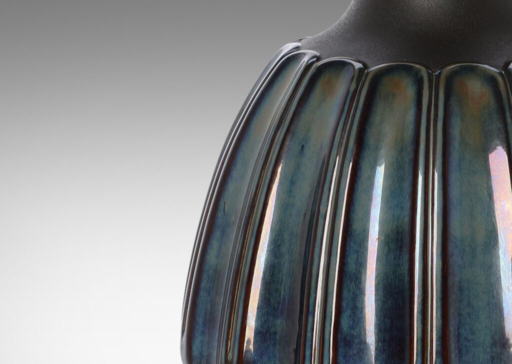 Gallery BAC large organically modeled rounded form with vertical flutes glazed in blue luster and shoulders in matte brown