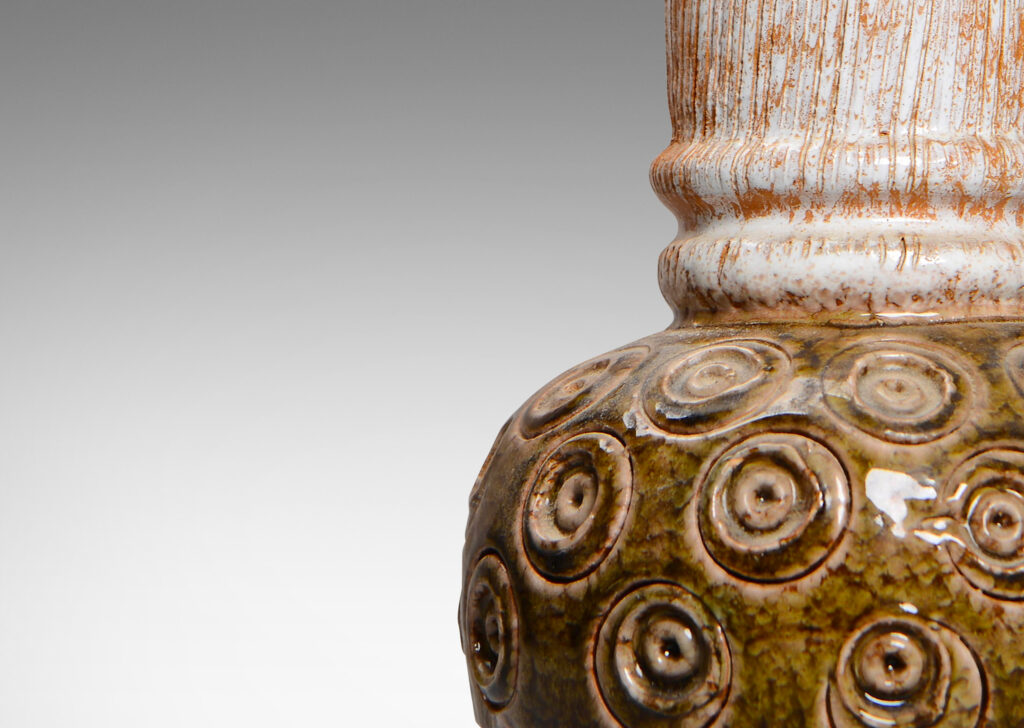 Gallery BAC globe form with carved concentric circle motifs in shiny olive green glaze, and a wide textured neck in partial white glaze