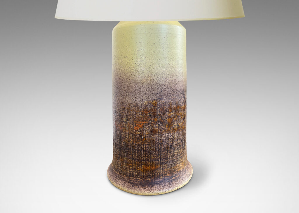 Gallery BAC cylindrical form with conical top and scored burlap-like texture on the lower half, glazed in a mellow yellow with splattered brown