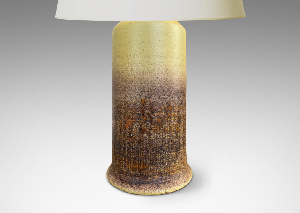 Gallery BAC cylindrical form with conical top and scored burlap-like texture on the lower half, glazed in a mellow yellow with splattered brown