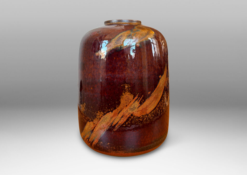 Gallery BAC straight-sided ovoid form glazed in a deep red-brown with abstract copper luster brushstroke designs