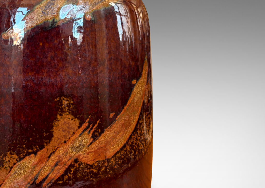 Gallery BAC straight-sided ovoid form glazed in a deep red-brown with abstract copper luster brushstroke designs