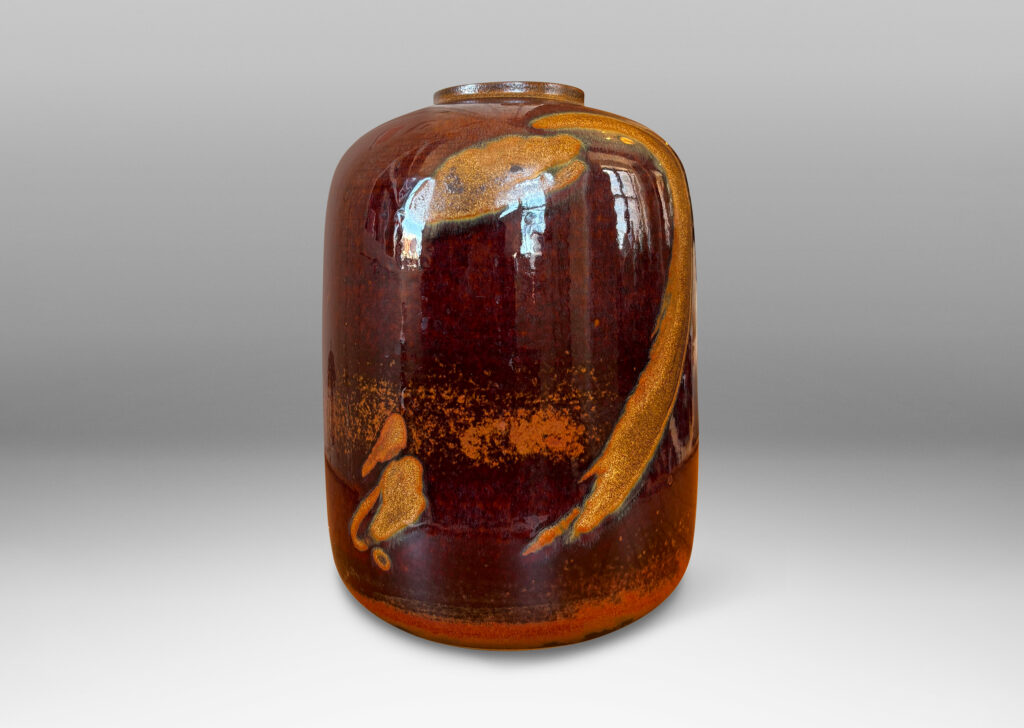 Gallery BAC straight-sided ovoid form glazed in a deep red-brown with abstract copper luster brushstroke designs