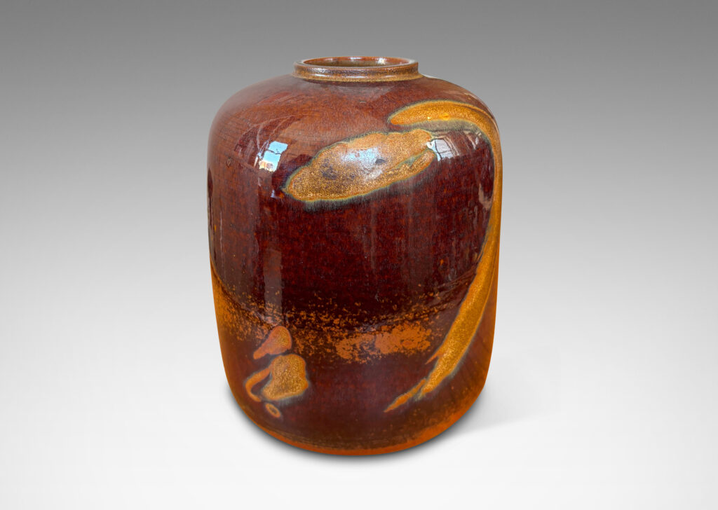Gallery BAC straight-sided ovoid form glazed in a deep red-brown with abstract copper luster brushstroke designs