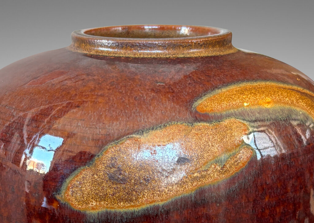 Gallery BAC straight-sided ovoid form glazed in a deep red-brown with abstract copper luster brushstroke designs