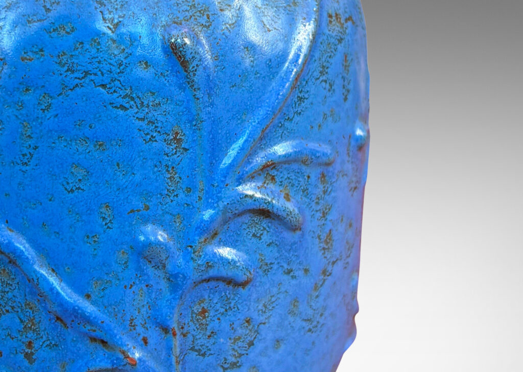 Gallery BAC straight-sided ovoid form with abstract botanical reliefs, glazed in a mottled cerulean-cornflower blue