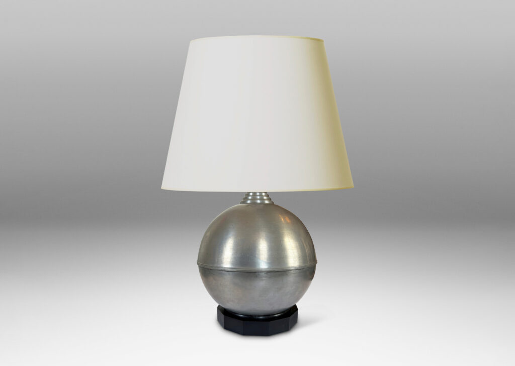 Gallery BAC arge globe form on an octagonal plinth; pewter or steel with ebonized wood