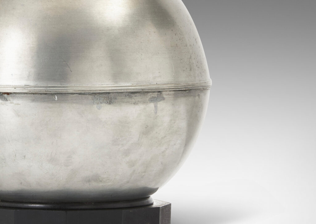 Gallery BAC arge globe form on an octagonal plinth; pewter or steel with ebonized wood
