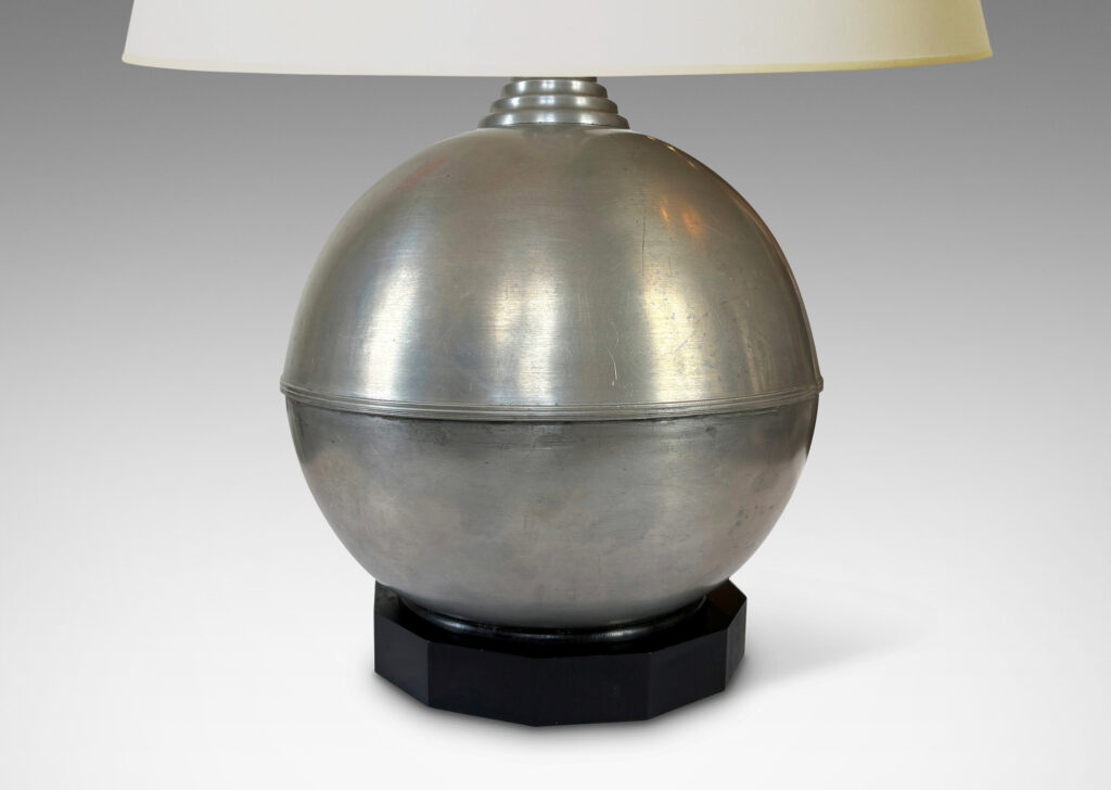 Gallery BAC arge globe form on an octagonal plinth; pewter or steel with ebonized wood