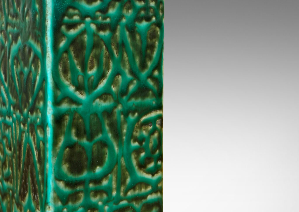 Gallery BAC square pillar forms with geometric designs in alpine green against a dark jungle green