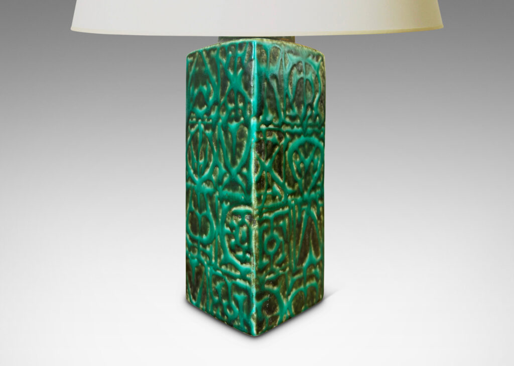 Gallery BAC square pillar forms with geometric designs in alpine green against a dark jungle green