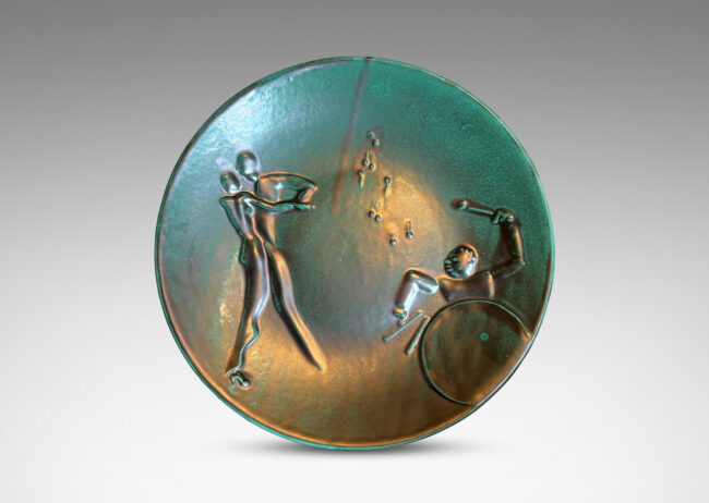 Gallery BAC wide convex form with reliefs depicting a dancing couple and drummer, finished in a tonal teal copper oxide glaze