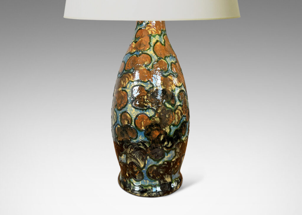 Gallery BAC undulating form with piped relief cloud-like pattern, with fields glazed in burnt orange and light blue