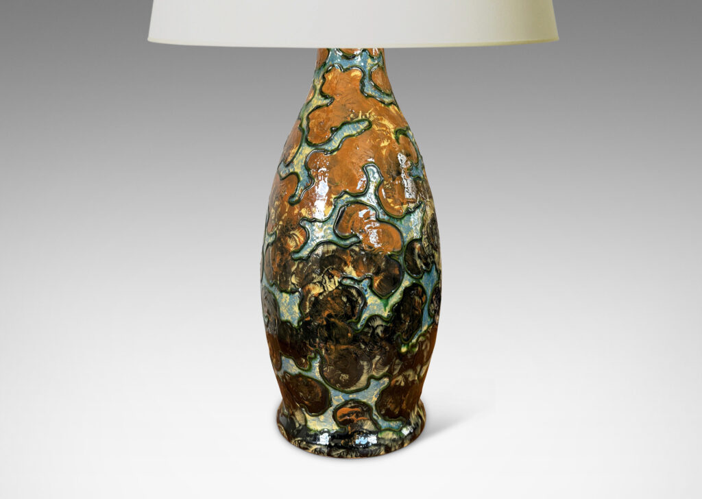 Gallery BAC undulating form with piped relief cloud-like pattern, with fields glazed in burnt orange and light blue