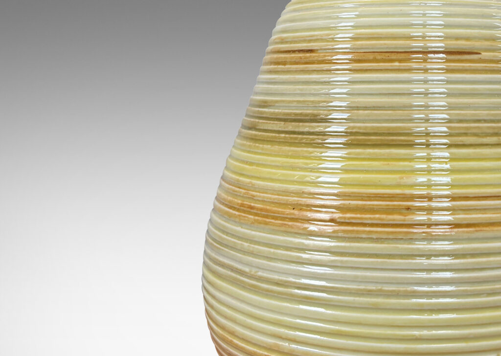 Gallery BAC ovoid form with horizontal pinstripe grooves, glazed in bands of pale yellow, mustard, and light brown