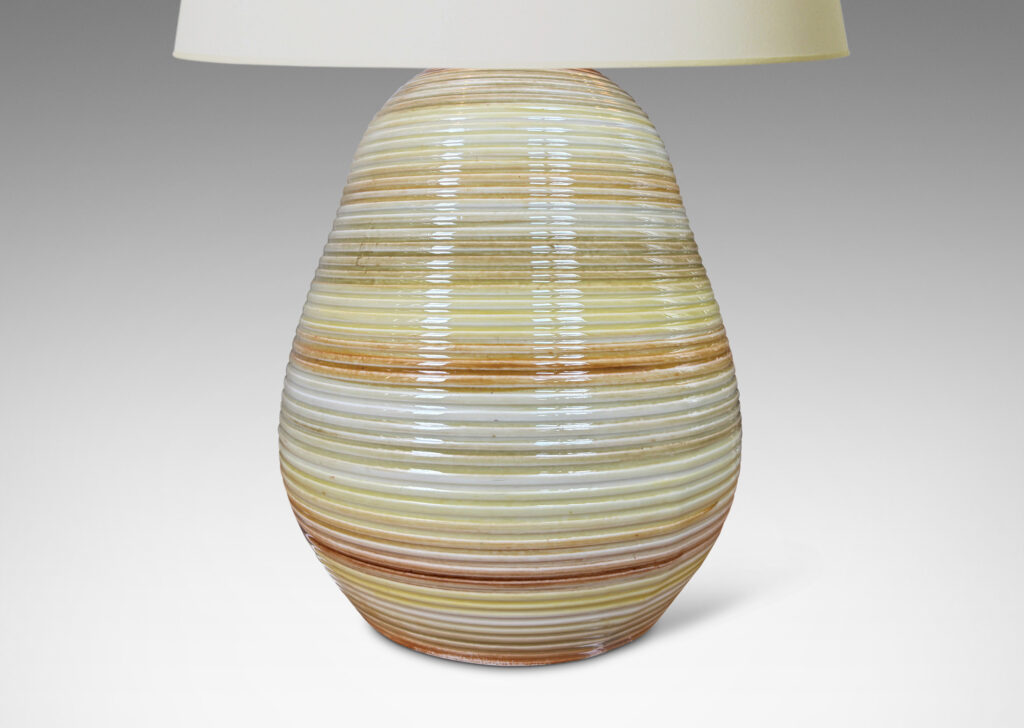 Gallery BAC ovoid form with horizontal pinstripe grooves, glazed in bands of pale yellow, mustard, and light brown