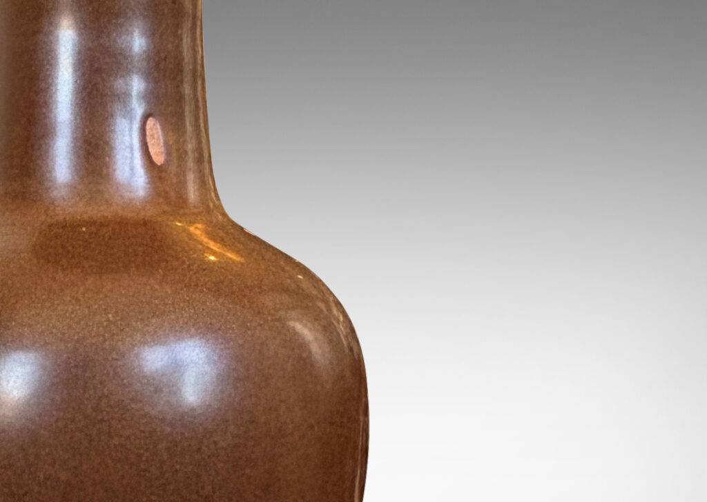 Gallery BAC void form glazed in a warm burnt sienna; stoneware