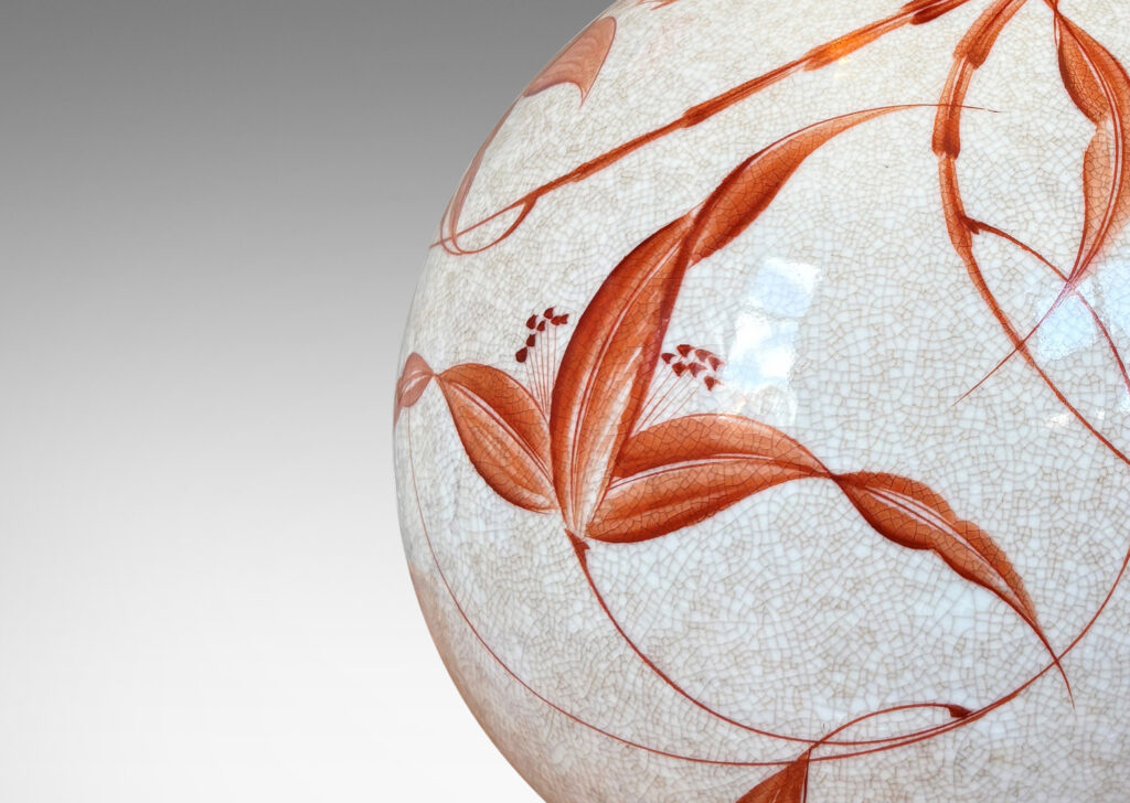 Gallery BAC globe form in white with a brown craquel, with leaf-form feet and fine hand-painted foliage in a coral-orange, and an original ornamented mount