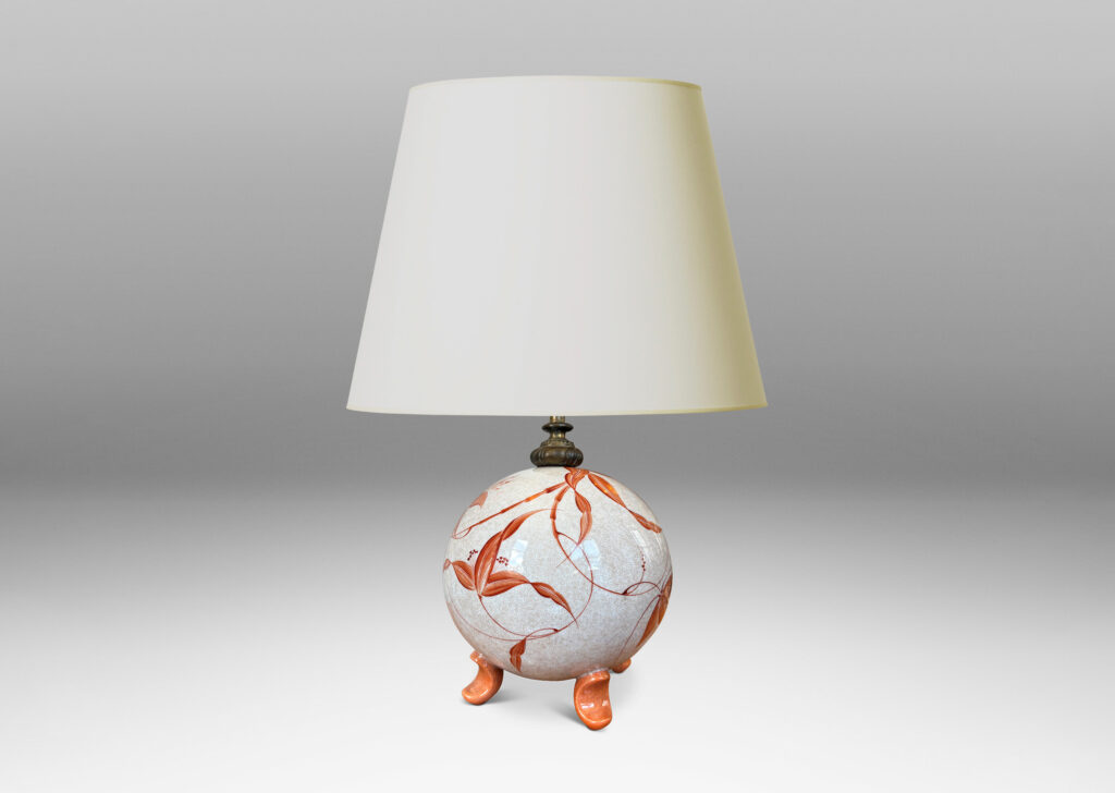 Gallery BAC globe form in white with a brown craquel, with leaf-form feet and fine hand-painted foliage in a coral-orange, and an original ornamented mount