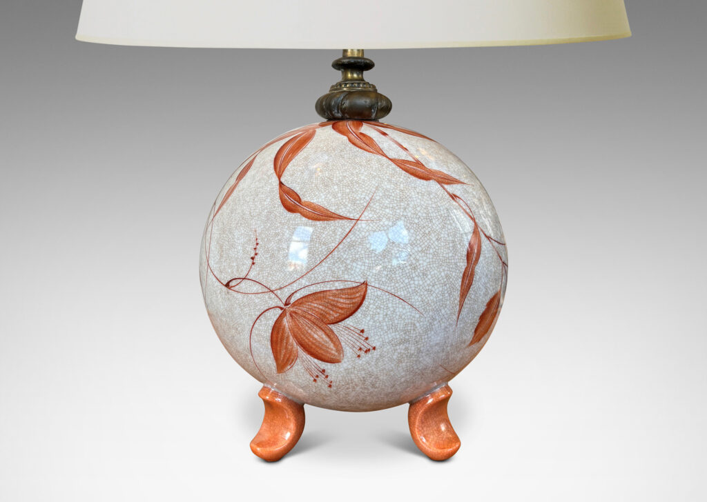Gallery BAC globe form in white with a brown craquel, with leaf-form feet and fine hand-painted foliage in a coral-orange, and an original ornamented mount