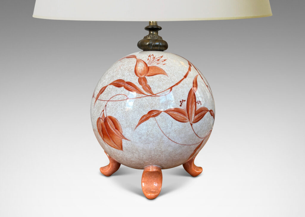 Gallery BAC globe form in white with a brown craquel, with leaf-form feet and fine hand-painted foliage in a coral-orange, and an original ornamented mount