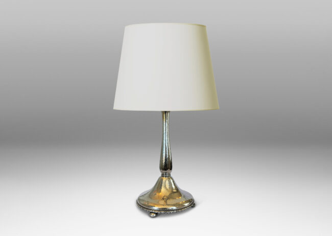 Gallery BAC sinuous baluster form on a pillowy round base, with a shimmering hammered finish and embossed foliate pattern bands, silver plate brass