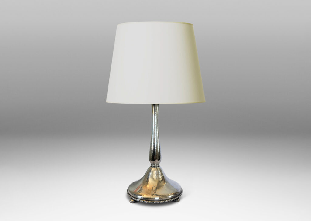 Gallery BAC sinuous baluster form on a pillowy round base, with a shimmering hammered finish and embossed foliate pattern bands, silver plate brass