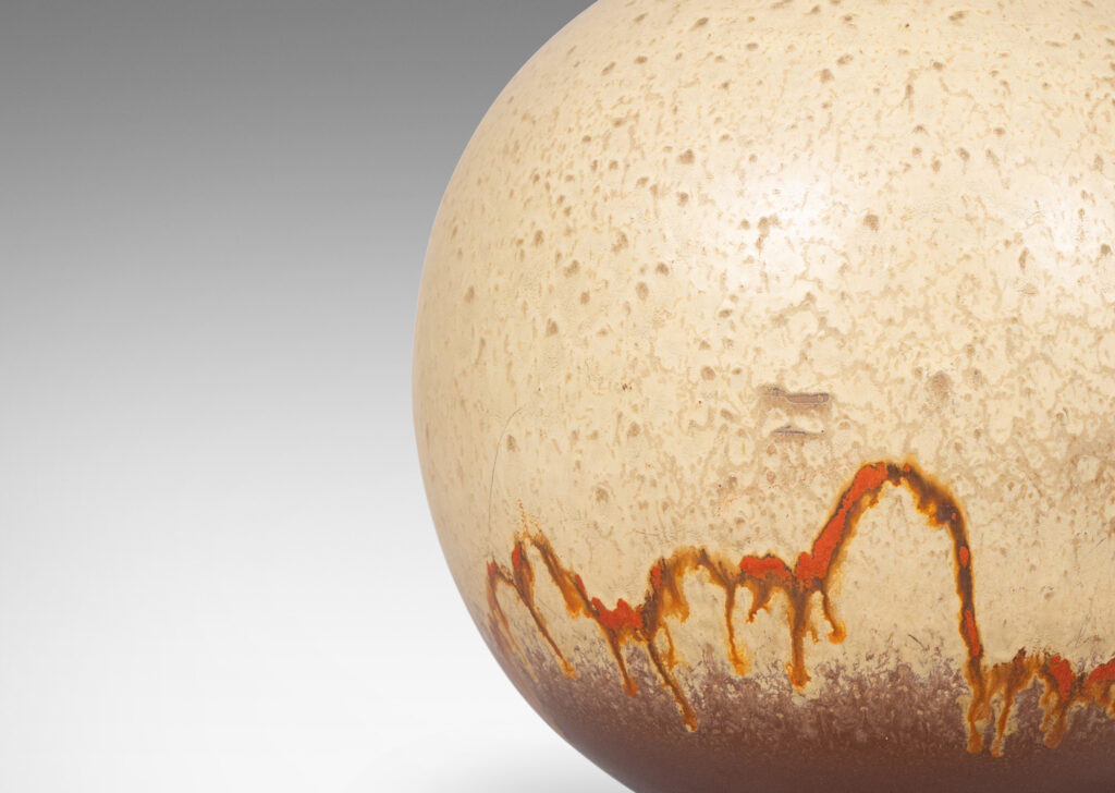 Gallery BAC globe form glazed in a pale taupe and brown, with a dripping line of orange