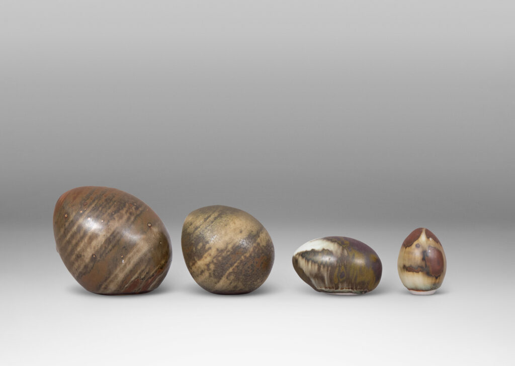 Gallery BAC egg forms in different sizes and sitting at different angles, each in a pale taupe and brown