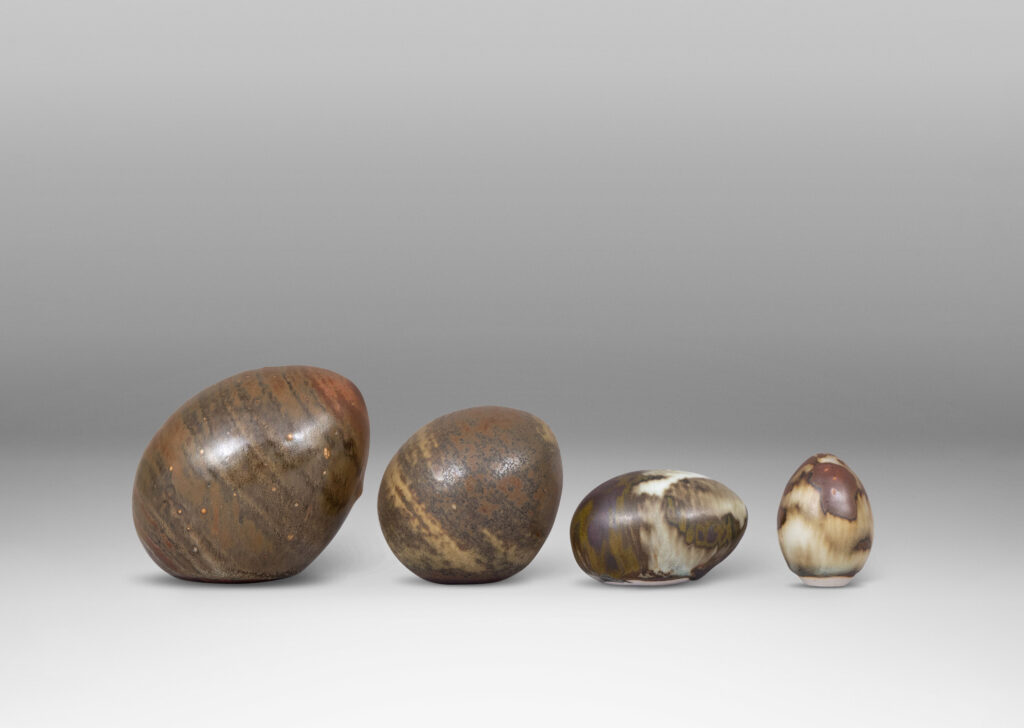 Gallery BAC egg forms in different sizes and sitting at different angles, each in a pale taupe and brown