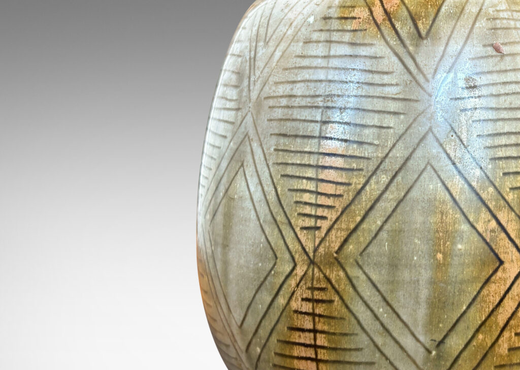 Gallery BAC swelling ovoid form carved with a diamond pattern design and gold-gray glaze wash