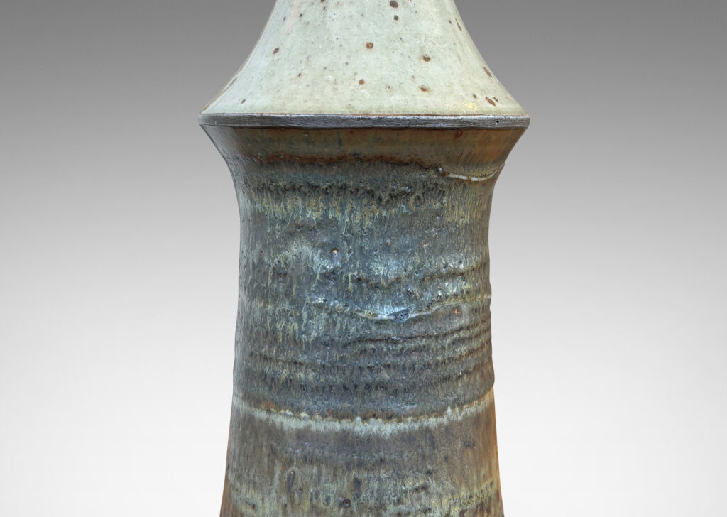 Gallery BAC organically modeled tiered form glazed in a speckled pale gray on top and flowing bands in gray tones below