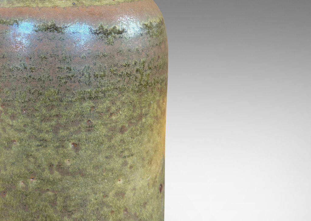 Gallery BAC cylindrical form with a narrow sprouting neck, glazed in atmospheric matte brown and shiny olive green