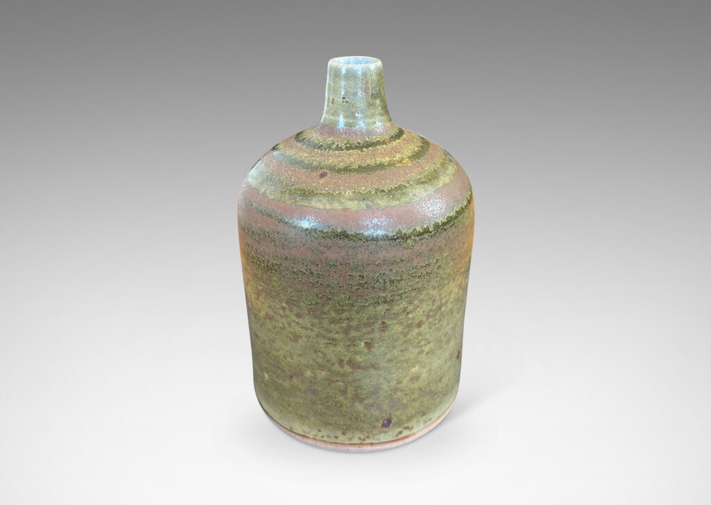 Gallery BAC cylindrical form with a narrow sprouting neck, glazed in atmospheric matte brown and shiny olive green