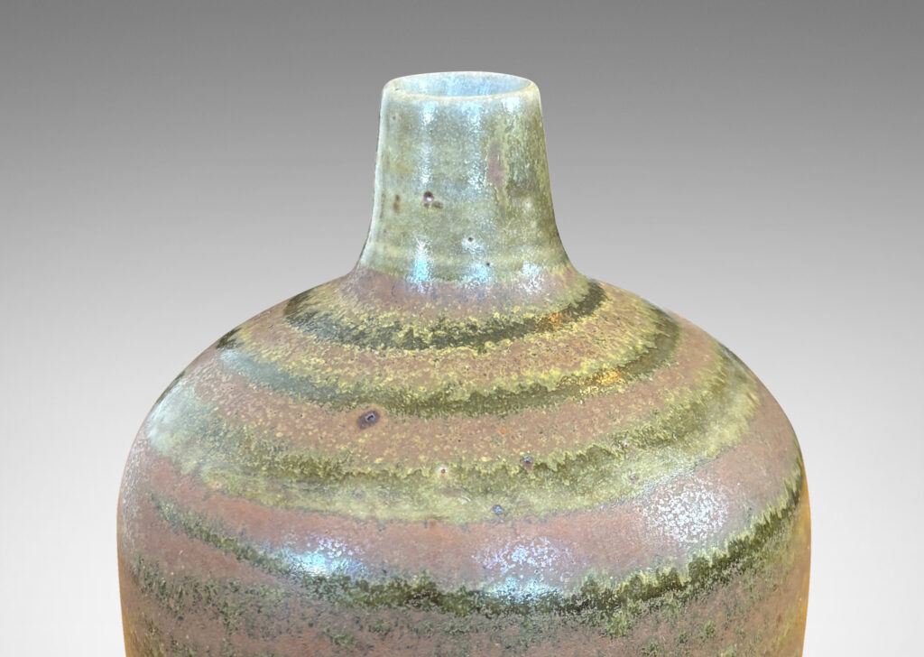 Gallery BAC cylindrical form with a narrow sprouting neck, glazed in atmospheric matte brown and shiny olive green