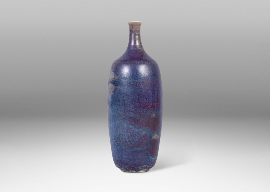 Gallery BAC organically modeled bottle-like form with attenuated neck and mouth, glazed in purple and burgundy