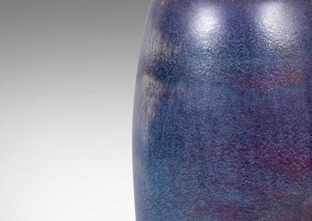Gallery BAC organically modeled bottle-like form with attenuated neck and mouth, glazed in purple and burgundy