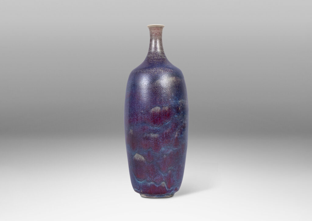 Gallery BAC organically modeled bottle-like form with attenuated neck and mouth, glazed in purple and burgundy