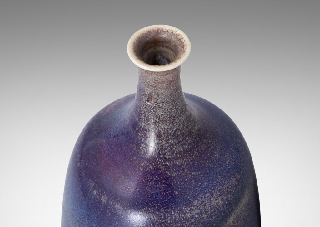 Gallery BAC organically modeled bottle-like form with attenuated neck and mouth, glazed in purple and burgundy