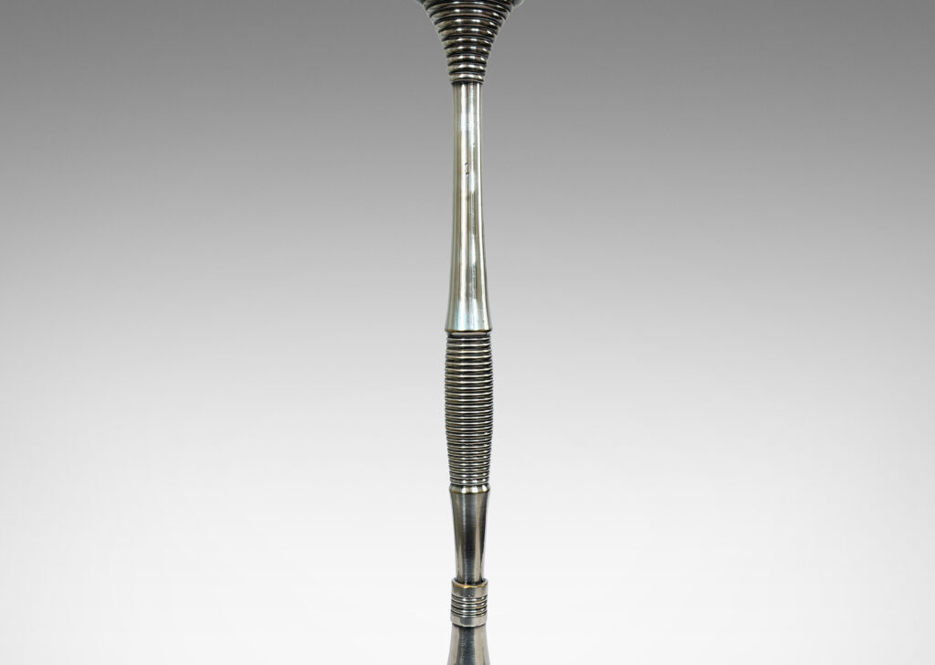 Gallery BAC swelling stand articulated with reeded and fluted bands springing from a disk base