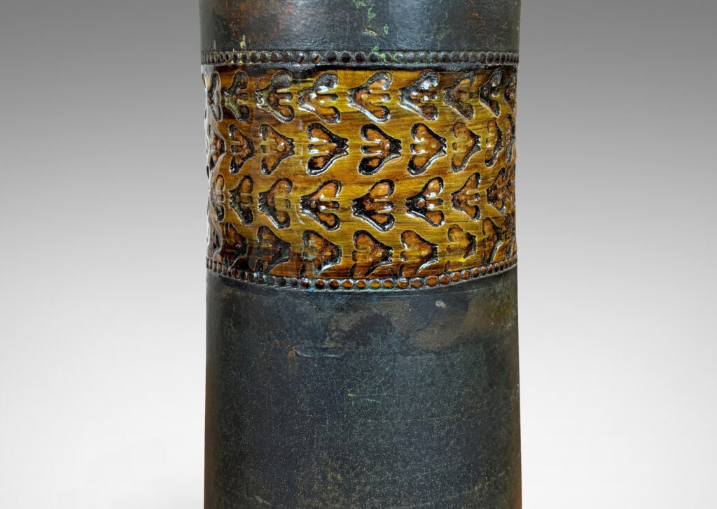 Gallery BAC rationalized canister form in matte brown, with wide bands with impressed ornaments glazed in a gloss coffee brown