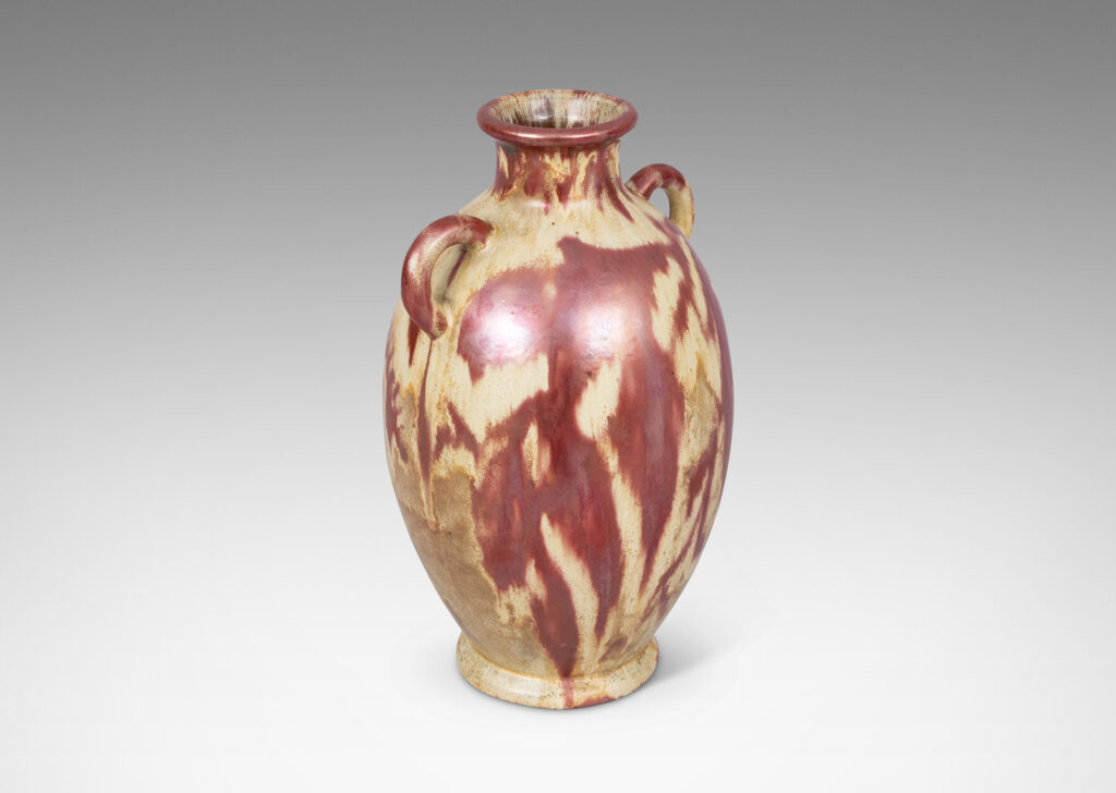 Gallery BAC large tapered ovoid form with pair of ear handles, glazed in sandy gold tones with abstract leaf design in red luster
